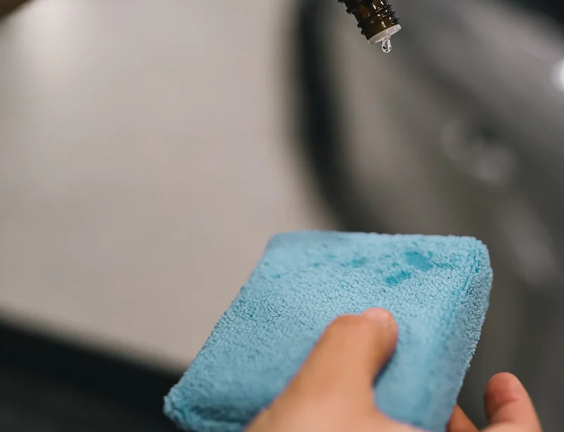 A drop of treatment above a microfibre applicator.