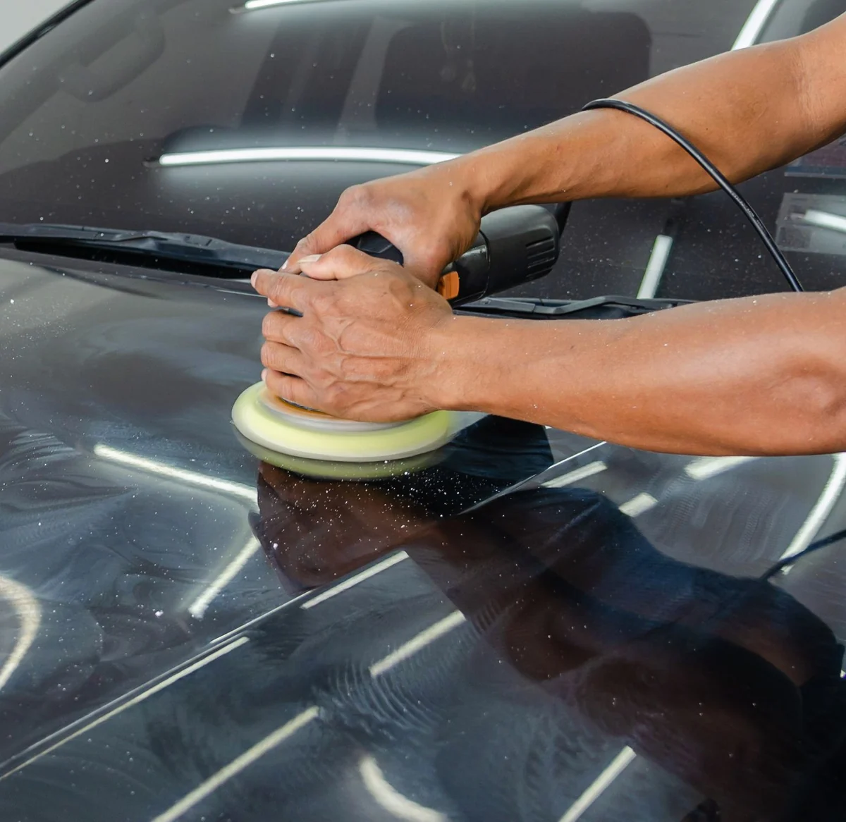 A close-up of polishing work and light reflected on bodywork.
